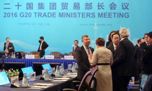 Attendees chat before the start of the opening session of the G-20 Trade Ministers Meeting in Shanghai on Saturday (AP photo)